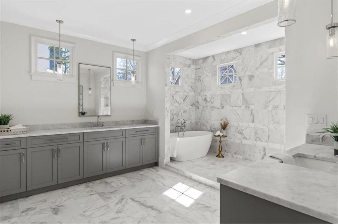 Luxury master bathroom remodel with marble tiles and custom gray vanity